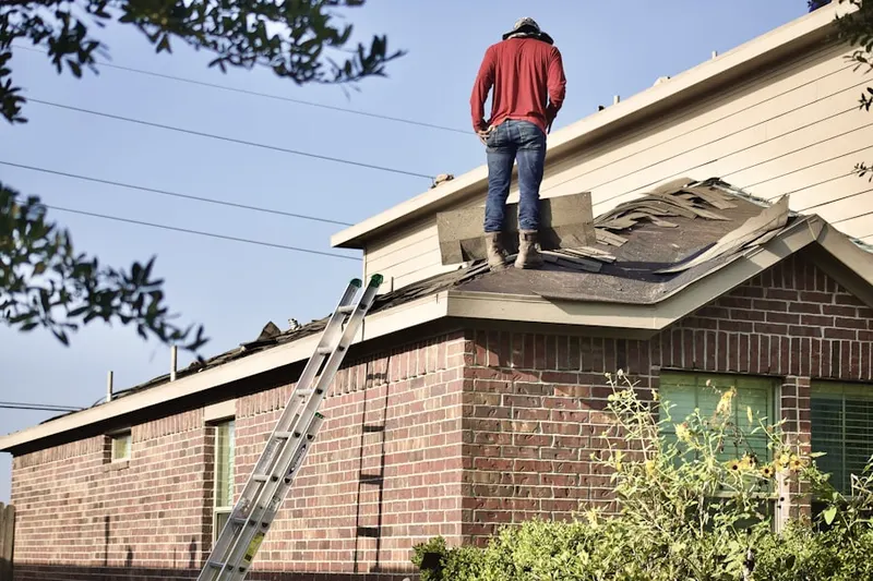 Professional roofer working on a residential roof in Gloria Dei Towers